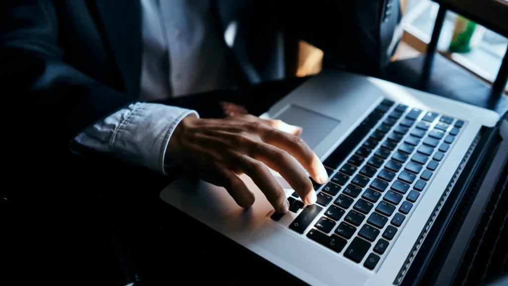 Image describing an admin of Telegram group using laptop
